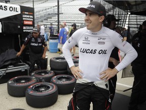FILE - In this May 21, 2018 file photo Robert Wickens, of Canada, waits in the pits before a practice session for the IndyCar Indianapolis 500 auto race at Indianapolis Motor Speedway, in Indianapolis. Wickens is returning to Road America with a full-time ride a year after taking his first IndyCar spin there as a substitute driver. The Schmidt Peterson racer is looking forward to the Kohler Grand Prix on Sunday at the 14-turn road course. Wickens was just subbing for one day of practice last year. Now an IndyCar rookie, Wickens is seventh in the points race heading into Sunday's race.