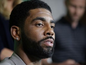 FILE - In this June 12, 2018 file photo Boston Celtics' Kyrie Irving takes questions from reporters during a news conference in Boston. Irving doesn't have to worry about free agency until next summer, though he's got plenty to keep him busy for now. There's a movie to promote and a knee to mend. He hopes he's good on screen, but wants to be better than ever on the court. "Now becomes the real climb to Mount Everest, back to the top," Irving said Monday, June 25, 2018. "So I'm just taking my time."