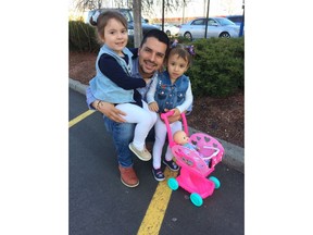 In this undated family photo provided by Sandra Chica, Pablo Villavicencio poses with his two daughters, Luciana, left, and Antonia. After Villavicencio couldn't produce a New York State Driver's License for identification, a guard at the Fort Hamilton in the Brooklyn borough of New York called Immigration and Customs Enforcement on him as he tried to deliver a pizza to the military base. Villavicencio was detained by military police and handed over to ICE pending removal from the country. (Villavicencio Family Photo via AP) .