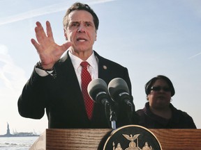 FILE - In this Jan. 21, 2018 file photo, New York Gov. Andrew Cuomo speaks during a news conference in New York, with the Statue of Liberty behind him. Leading up to New York's September 2018 Democratic gubernatorial primary, former "Sex and the City" star and liberal activist Cynthia Nixon, up against Cuomo, is taking inspiration from Alexandria Ocasio-Cortez's long-shot victory in the Tuesday, June 26, 2018 Democratic congressional primary.