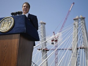 FILE - In this Thursday Aug. 24, 2017 photo, New York Gov. Andrew Cuomo speaks during a ribbon cutting ceremony for the Tappan Zee Bridge replacement near Tarrytown, N.Y., renamed the Gov. Mario M. Cuomo Bridge. Gov. Cuomo says a petition to take his late father's name off a new bridge is "personally hurtful."