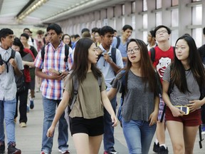 FILE - In this Sept. 9, 2015 file photo, students arrive for the first day of school at Stuyvesant High School in New York. A push to diversify New York City's most elite public high schools is facing a backlash from the group that makes up most of the schools' current student bodies: Asian-Americans.