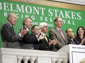 President and CEO of WinStar Farm W. Elliott Walden, second from right, is applauded by Bob Baffert, third left, trainer of Triple Crown hopeful Justify, and New York Stock Exchange President Stacey Cunnigham, right, as he rings the New York Stock Exchange opening bell Wednesday, June 6, 2018.