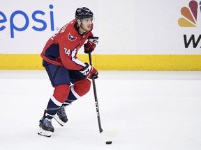 File- This May 17, 2018, file photo shows Washington Capitals defenseman John Carlson (74) skating with the puck during the third period of Game 4 of the NHL Eastern Conference finals hockey playoff series against the Tampa Bay Lightning in Washington. A person with knowledge of the move says the Capitals have re-signed Carlson to a $64 million, eight-year contract. The person spoke to The Associated Press on condition of anonymity Sunday, June 24, 2018, because the deal hadn't yet been announced.