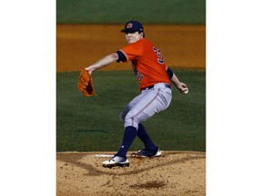 File-This May 24, 2018, file photo shows Auburn pitcher Casey Mize throwing during the first inning of a Southeastern Conference tournament NCAA college baseball game against Texas A&M in Hoover, Ala.  Mize has dazzled scouts for months with his impressive arsenal of pitches. The tantalizingly talented Auburn right-hander could find himself leading off the Major League Baseball draft on Monday night, with the Detroit Tigers ready to go on the clock with the No. 1 pick.