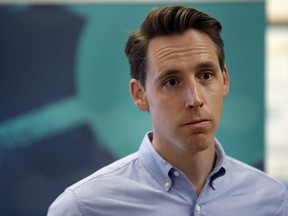FILE - In a Friday, May 25, 2018 file photo, Missouri Attorney General and Republican U.S. Senate candidate Josh Hawley takes questions from the media after touring the POET Biorefining ethanol plant, in Macon, Mo. A Democratic political action committee is targeting Hawley over allegations of corruption by a past top donor, although Hawley's authority to take action against the donor is limited. A Senate Majority PAC ad claims Hawley is "refusing to investigate" as attorney general.