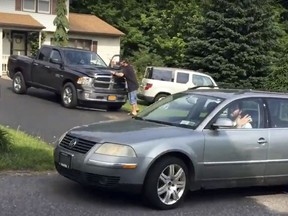 Michael Rotondo, 30, waves as he drives away from his his parents' house in Camillus, N.Y., Friday, June 1, 2018. Rotondo, whose eviction from his parents' home drew national attention finally left Friday, hours before a court-ordered deadline.