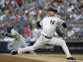 New York Yankees starting pitcher Jonathan Loaisiga throws during the first inning of a baseball game against the Seattle Mariners at Yankee Stadium Wednesday, June 20, 2018, in New York.