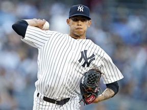 New York Yankees pitcher Jonathan Loaisiga throws to first base to check on a Tampa Bay Rays base runner during the first inning of a baseball game on Friday, June 15, 2018, in New York. Loaisiga was making his major league debut.