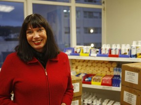 In this Tuesday, June 5, 2018, photo, Catherine Healy, the national coordinator of the New Zealand Prostitutes' Collective, stands in front of supplies at the collective's office in Wellington, New Zealand. Healy was honored this week by Britain's Queen Elizabeth II for her work advocating for sex workers.