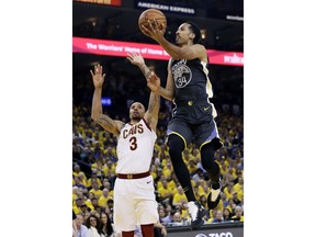 Golden State Warriors guard Shaun Livingston (34) shoots against Cleveland Cavaliers guard George Hill (3) during the first half of Game 2 of basketball's NBA Finals in Oakland, Calif., Sunday, June 3, 2018.