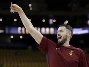 Cleveland Cavaliers forward Kevin Love warms up before Game 1 of basketball's NBA Finals between the Golden State Warriors and the Cavaliers in Oakland, Calif., Thursday, May 31, 2018.