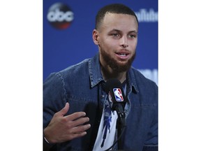 Golden State Warriors guard Stephen Curry speaks at a news conference after Game 2 of basketball's NBA Finals between the Warriors and the Cleveland Cavaliers in Oakland, Calif., Sunday, June 3, 2018. The Warriors won 122-103.