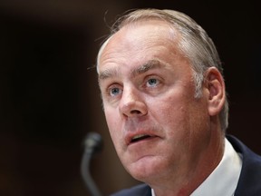 FILE - In this May 10, 2018, file photo, Interior Secretary Ryan Zinke testifies at a Senate Appropriations subcommittee hearing on the FY19 budget, on Capitol Hill in Washington. Interior Secretary Ryan Zinke's family is involved in a land deal with the head of an energy services giant that has business with the Interior Department. Politico first reported the Zinkes' dealings with Halliburton chairman David Lesar for a planned commercial development in Zinke's hometown of Whitefish, Mont.