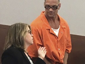 FILE - In this Aug. 17, 2017 file photo, Nevada death row inmate Scott Raymond Dozier confers with Lori Teicher, a federal public defender involved in his case, during an appearance in Clark County District Court in Las Vegas. A judge says the first execution in Nevada in 12 years can go forward next month, after the state Supreme Court rejected a challenge of a never-before-tried combination of drugs for the lethal injection. Dozier's death warrant, signed Tuesday, June 19, 2018, in Las Vegas, sets an unspecified date the week of July 9 for his execution at the state prison in Ely.
