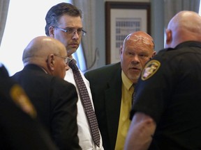 FILE - In this May 7, 2018, file photo, Shawn Grate, center left, listens to his attorneys Robert Whitney, left, and Rolf Whitney during a trial in Ashland, Ohio. Grate, convicted of strangling two women and suspected in two more deaths, is scheduled to be sentenced Friday, June 1, after an Ohio jury recommended that he get the death penalty.