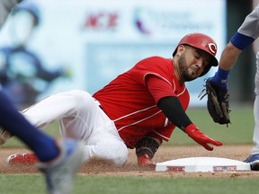 Cincinnati Reds' Eugenio Suarez slides into third safely against Chicago Cubs third baseman Tommy La Stella with a triple during the seventh inning of a baseball game Saturday, June 23, 2018, in Cincinnati.