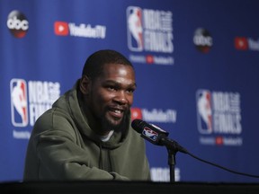 Golden State Warriors forward Kevin Durant takes questions at a press conference before the basketball team's practiced during the NBA Finals, Thursday, June 7, 2018, in Cleveland. The Warriors lead the series 3-0 with Game 4 on Friday.