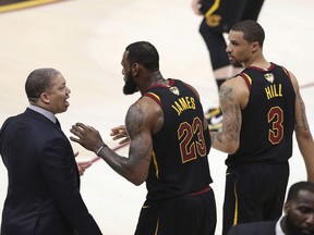 Cleveland Cavaliers' LeBron James (23) talks with coach Tyronn Lue during the second half of Game 4 of basketball's NBA Finals against the Golden State Warriors, Friday, June 8, 2018, in Cleveland.