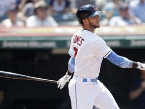 Cleveland Indians' Yan Gomes watches his three-run double in the third inning of a baseball game against the Minnesota Twins, Sunday, June 17, 2018, in Cleveland. Michael Brantley, Edwin Encarnacion and Lonnie Chisenhall scored on the play.