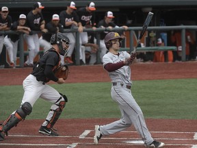 FILE - In this Friday, June 8, 2018, file photo, Minnesota's Terrin Vavra, right, reacts after striking out as Oregon State catcher Adley Rutschman, left, heads to the dugout in the first inning of an NCAA college baseball tournament super regional game in Corvallis, Ore. The number of strikeouts in college baseball is the highest on record entering the College World Series. Coaches say conditions are right for strikeouts. They say the pitching has never been better in college baseball and the focus on launch angles and exit velocities make batters more prone to striking out.