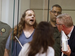 FILE--In this May 30, 2017, file pool photo, Jeremy Christian shouts as he is arraigned in Multnomah County Circuit Court in Portland, Ore. Many Portland residents say they love their city's reputation for political dissent but are dismayed it has become a spotlight for violence.