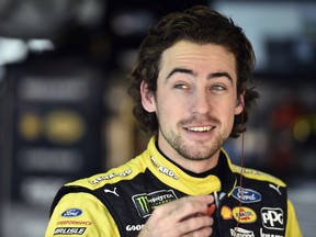 Ryan Blaney smiles in the garage prior to a practice session for Sunday's NASCAR Cup Series auto race, Saturday, June 2, 2018, in Long Pond, Pa.