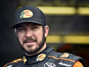 Martin Truex Jr. looks out from the garage area during practice for Sunday's NASCAR Cup Series auto race, Saturday, June 2, 2018, in Long Pond, Pa.