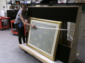 Collections manager Michelle Moskal secures the Commander-in-Chief's Standard, Wednesday, June 13, 2018, before moving it to an exhibition gallery at the Museum of the American Revolution in Philadelphia. The faded and fragile blue silk flag marked General George Washington's presence on the battlefield during the Revolutionary War. The museum is bringing the flag out of its archives for public viewing on Thursday, June 14, Flag Day, until Sunday. Its appearance at the museum is the flag's first public display in Philadelphia since the war.