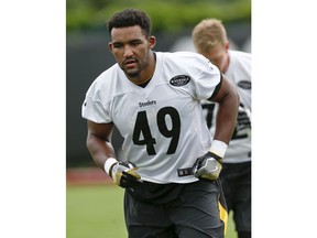 In this photo from May 31, 2018, Pittsburgh Steelers tight end Christian Scotland-Williamson (49) participates in warmup drills during NFL football practice, in Pittsburgh. Scotland-Williamson knew little about football until January. Now the former rugby player from London is in the midst of what amounts to a one-year internship with the Pittsburgh Steelers as part of the NFL's International Player Pathway Program. The 6-foot-9, 275-pounder is learning the game one snap at a time.