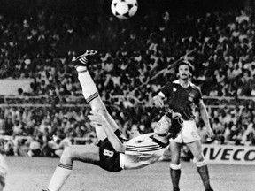 FILE - In this July 8, 1982 file photo, West Germany's Klaus Fischer scores the third goal and equalizes, in the World Cup semifinal soccer match against France, in Seville, Spain. West Germany defeats France in a penalty shoot out after a 3-3 draw. The 21st World Cup begins on Thursday, June 14, 2018, when host Russia takes on Saudi Arabia.  (AP Photo/File)