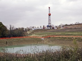 FILE – In this Oct. 29, 2008, file photo, a drilling rig used to extract natural gas from the Marcellus Shale, located on a hill above a pond on John Dunn's farm in the Washington County borough of Houston, Pa. New research suggests drinking water supplies in Pennsylvania have shown resilience in the face of a drilling boom that has turned swaths of countryside into a major production zone for natural gas.