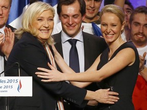 FILE - This Thursday, Dec. 10, 2015 shows French far-right National Front Party leader, Marine Le Pen, left, greeting National Front regional leader for southeastern France, Marion Marechal, after a meeting in Paris. Far-right leader Marine Le Pen is announcing on Thursday a name-change for her National Front party, founded by her father nearly a half-century ago, expected to become the National Rally in a bid to more broadly embrace French voters ahead of next year's European elections.