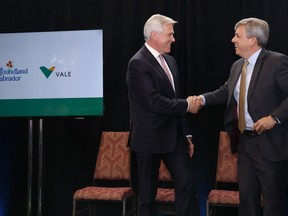 Newfoundland and Labrador Premier Dwight Ball, left, and Eduardo Bartolomeo, Vale executive director, base metals shake hands after an announcement in St. John's on Monday, June 11, 2018, that construction of the Voisey's Bay underground mine will proceed this summer.