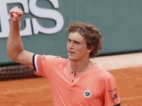 Germany's Alexander Zverev celebrates winning his third round match of the French Open tennis tournament against Bosnia and Herzegovina's Damir Dzumhur in five sets 6-2, 3-6, 4-6, 7-6, 7-5, at the Roland Garros stadium in Paris, France, Friday, June 1, 2018.