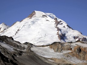 FILE--In this Aug. 7, 2015, file photo, Mount Baker, Wash., is visible during a clear morning. Search and rescue officials say four Scouts are missing in an attempted summit of Mount Baker in Washington state.