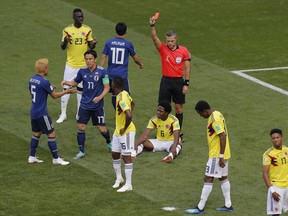 Referee Damir Skomina from Slovenia shows a red card to Colombia's Carlos Sanchez, on the ground, during the group H match between Colombia and Japan at the 2018 soccer World Cup in the Mordavia Arena in Saransk, Russia, Tuesday, June 19, 2018.