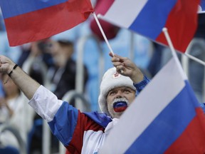 Fan waves a flag prior the group A match between Russia and Egypt at the 2018 soccer World Cup in the St. Petersburg stadium in St. Petersburg, Russia, Tuesday, June 19, 2018.