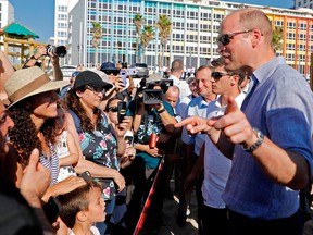 Reporters and beach-goers swarm around Prince William in Tel Aviv on June 26, 2018.