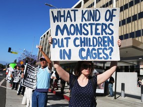 People protest the separation of migrant children from their families, in front of the Federal Building in Los Angeles, Calif., on June 18, 2018.