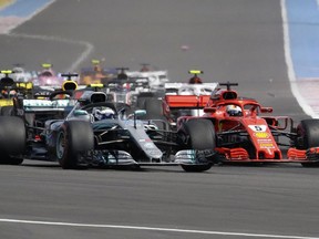 Mercedes driver Valtteri Bottas of Finland, left and Ferrari driver Sebastian Vettel of Germany take a curve together during the French Formula One Grand Prix at the Paul Ricard racetrack, in Le Castellet, southern France, Sunday, June 24, 2018.