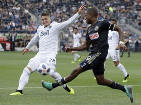 Philadelphia Union's Fafa Picault (9) tries to get the ball past Vancouver Whitecaps's Jake Nerwinski (28) during the first half of an MLS soccer match, Saturday, June 23, 2018, in Chester, Pa.