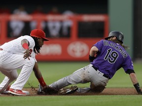 Philadelphia Phillies third baseman Maikel Franco, left, tags out Colorado Rockies' Charlie Blackmon at second base after Blackmon tried to steal during the first inning of a baseball game, Wednesday, June 13, 2018, in Philadelphia.