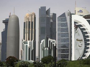 In this May 5, 2018 photo, a giant image of the Emir of Qatar Sheikh Tamim bin Hamad Al Thani, adorns a tower in Doha, Qatar. At a time when the U.S. hopes to exert maximum pressure on Iran, a regional bloc created by Gulf Arab countries to counter Tehran looks increasingly more divided ahead of the anniversary of the diplomatic crisis in Qatar.