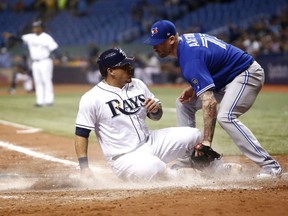 Wilson Ramos of the Tampa Bay Rays scores ahead of the tag from Toronto Blue Jays pitcher John Axford during MLB action Monday night in Tropicana Field in St. Petersburg, Fla. The Rays were 8-4 winners.