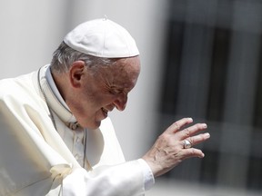 Pope Francis waves to faithful as he leaves at the end of his weekly general audience, in St. Peter's Square, at the Vatican, Wednesday, June 13, 2018.