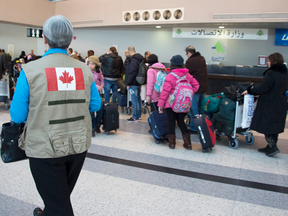 A group of Syrian refugees wait at the Beirut International airport as they prepare to depart to resettle in Canada, Dec. 10, 2015.