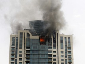 Flames rise from Beau Monde Tower building in Mumbai, India, Wednesday, June 13, 2018.  A fire official says a major fire has broken out on the 33rd floor of the upscale residential apartment building in Mumbai, India's financial and entertainment capital. The cause of the fire is not immediately known. No injuries have been reported so far.