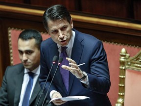 Premier Giuseppe Conte addresses the Senate, with 5-Star Movement leader Luigi di Maio sitting behind him, in Rome, Tuesday, June 5, 2018. In his first policy statement, Conte addresses the upper Senate chamber on Tuesday and the lower Chamber of Deputies on Wednesday, capping an extraordinary week that saw the installation of Western Europe's first populist government after three months of political and financial turmoil.