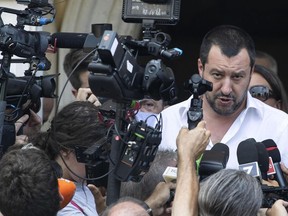 Italian Interior Minister Matteo Salvini talks with journalists on the occasion of the visit in the 'villa' confiscated at Mafia's Casamonica family in Rome, Tuesday,  June 21, 2018. Italy's hardline migrant policy is in the spotlight after its new government turned away a rescue boat, a pointed signal that the country has had enough of coping with the migrant influx to European shores. Interior Minister Matteo Salvini has quickly proclaimed his next urgent mission: kicking out huge numbers of migrants already here.